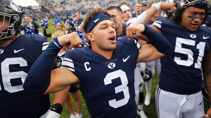 BYU football quarterback Jaren Hall flexes after a win